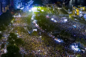 an aerial night shot of the crowds filling Santa Cruz's seafront.